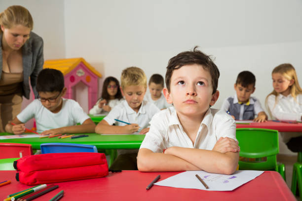 istock Portrait of bored schoolboy 1166156115
