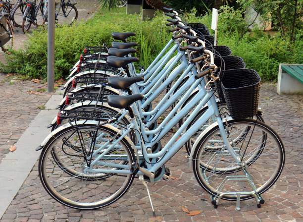 istock New identical blue women bicycles  lined up on a sidewalk 1166156456