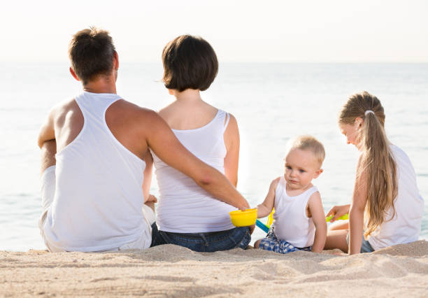 istock Glad family and kids sitting with back forward 1166156467