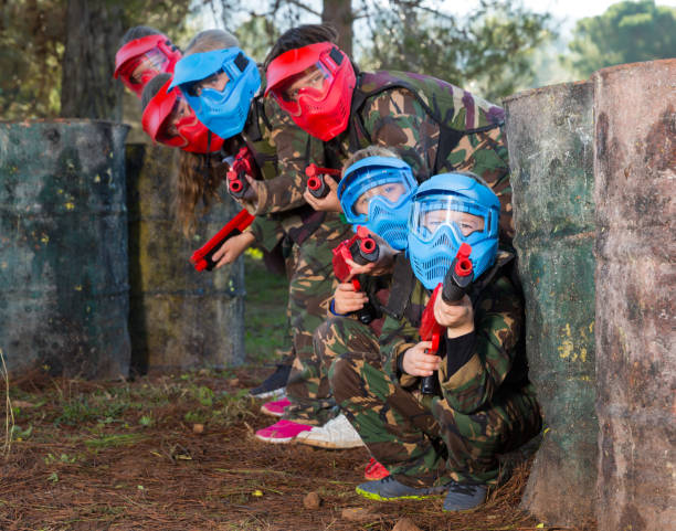 istock Group of friendly kids playing paintball 1166157966