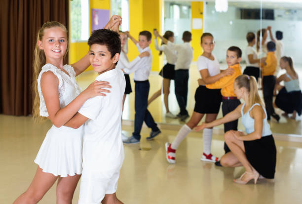 istock Little boys and girls having dancing class in classroom 1166159048