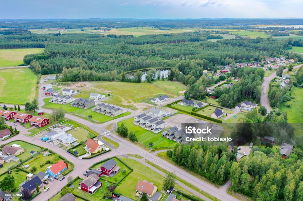 Residential houses surrounded by green landscape A small community of villas surrounded by green forest and wide meadows in the country of Sweden. The place is Stodene and is located 10 kilometers north of the city of Karlstad, Sweden. Denmark Stock Photo