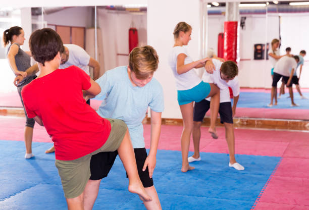 istock Kids exercising self-defense movements 1166161178