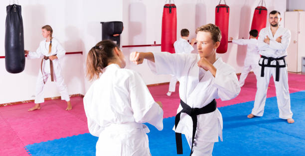 istock Children working in pair mastering new karate moves 1166161186