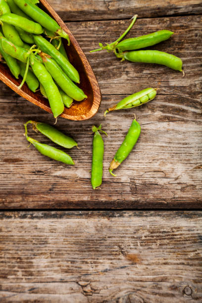 istock Green peas in a wooden bowl. 1166161322
