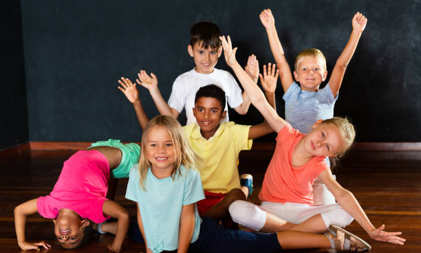 istock Girls and boys holding hands up in dancing class 1166161431