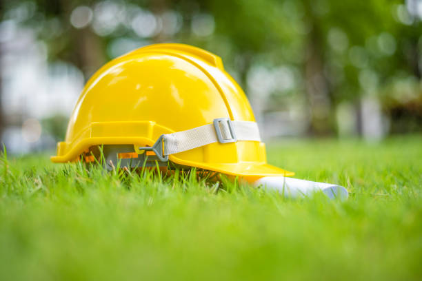 istock Yellow helmet on green background, save earth engineering concept 1166161438