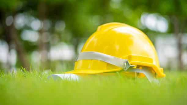 istock Yellow helmet on green background, save earth engineering concept 1166162242