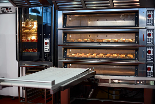 Industrial convection oven with cooked bakery products for catering. Professional kitchen equipment, Professional industrial equipment.