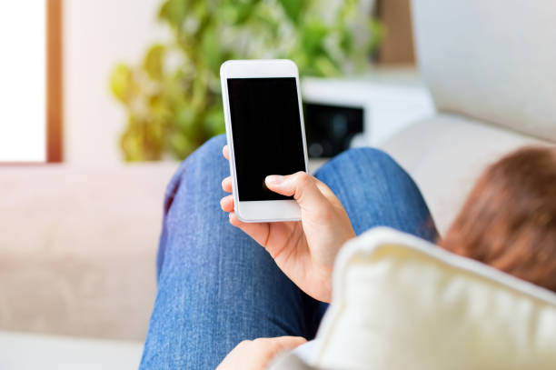 istock woman using smartphone at home 1166163557