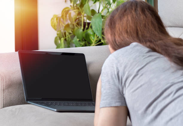 istock woman watching media content in a laptop 1166163566