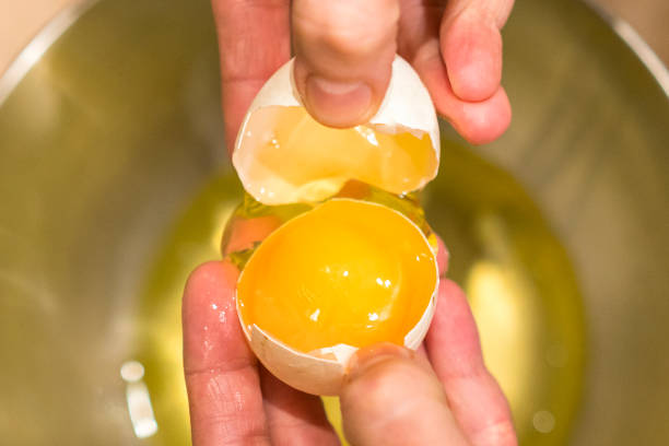 istock A woman holding an open chicken egg in her hands 1166165168