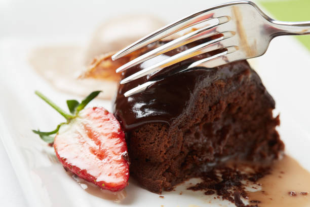 istock Close-up of fork cutting into restaurant's delicious chocolate dessert 1166166178
