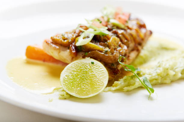 istock Delicious-looking fish dish with lime slice in elegant restaurant 1166166258