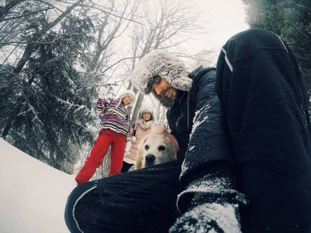 istock Smiling friends with camera in winter forest 1166167814