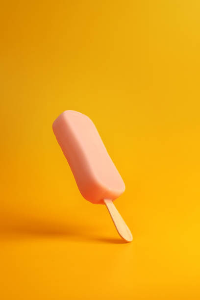 istock pink ice cream popsicle on yellow background 1166167921