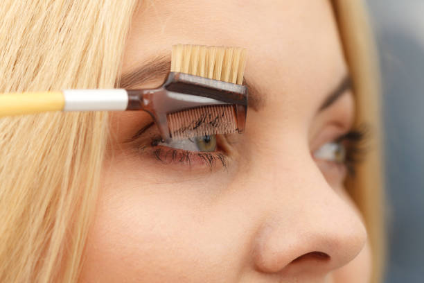 istock Woman brushing her eyelashes 1166171651