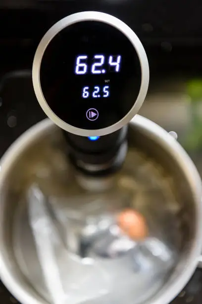 Photo of Sous Vide water bath circulator cooking a single egg at 62.5C for a very soft boiled egg.