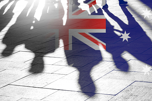Australian Flag as Background and Silhouettes of People - conceptual Picture about Independence Vote Patriotism political situation and Migrants