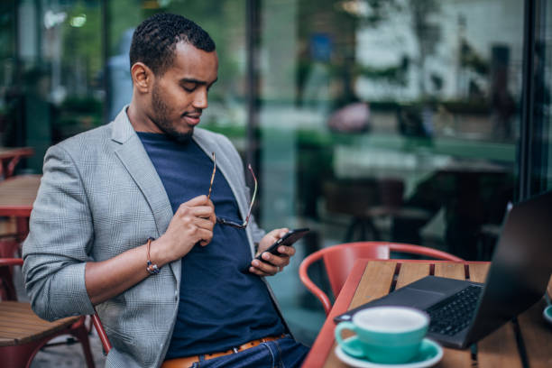 istock Black man sitting outdoors in cafe 1166175863