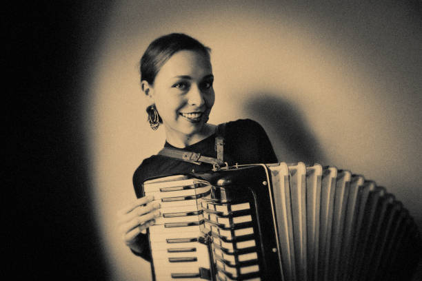 istock Young Woman with old Accordion 1166175876