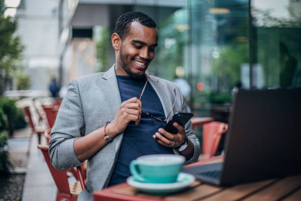 istock Black man sitting in sidewalk cafe 1166175878