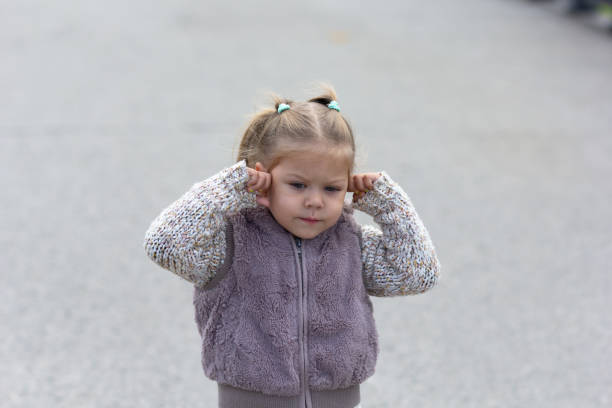istock Child does not want to hear anything closing her ears by hands 1166176226