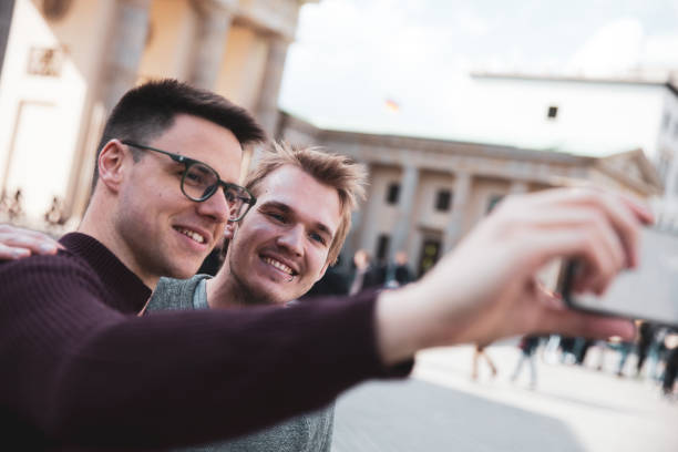 istock Two men visiting together Berlin - Brandenburg Gate 1166176662