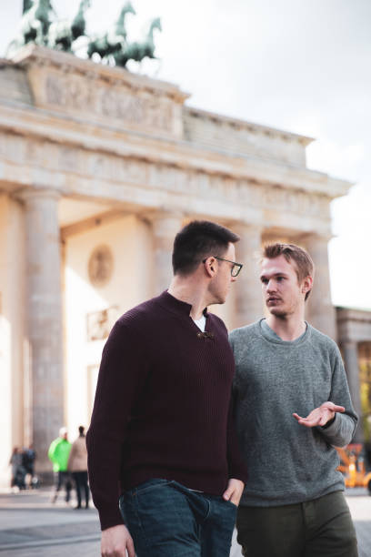 istock Two men visiting together Berlin - Brandenburg Gate 1166176682