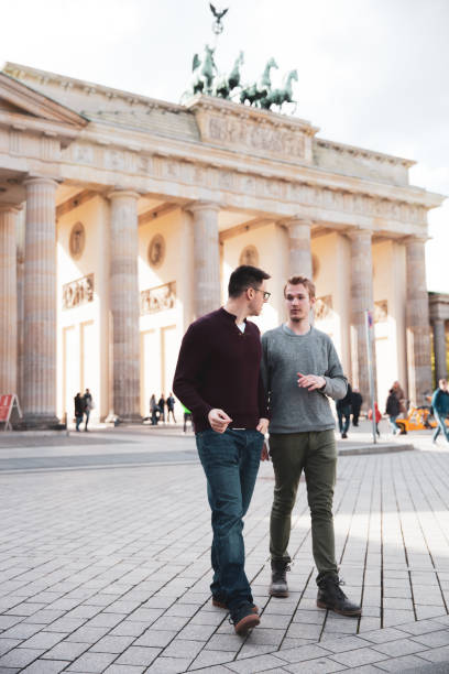 istock Two men visiting together Berlin - Brandenburg Gate 1166176696