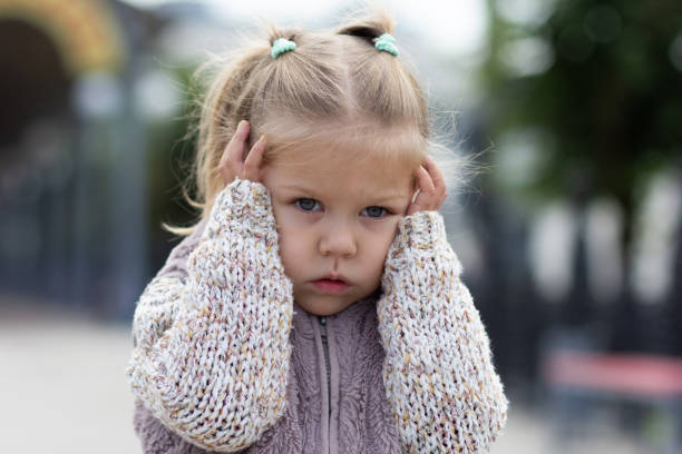istock Child holding her head by hands feeling stress 1166176948