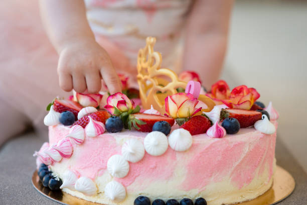 istock The baby's hand shows cake decorations. Close-up photograph. 1166177035