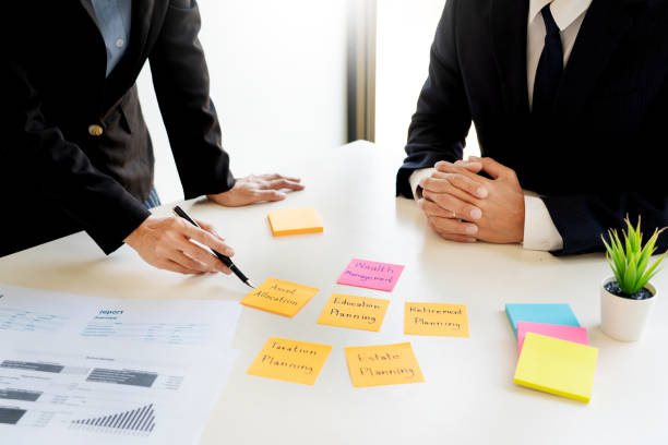 istock Midsection Of Businessman And Colleague Working On Table 1166177166