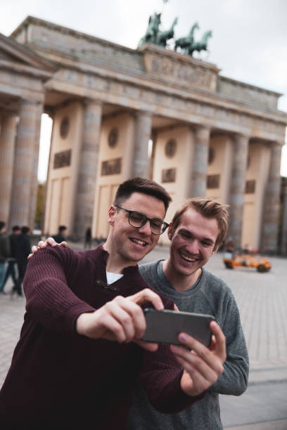 istock Two men visiting together Berlin - Brandenburg Gate 1166177853