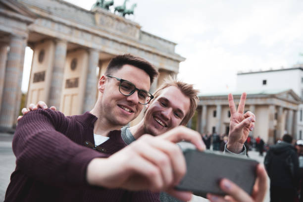 istock Two men visiting together Berlin - Brandenburg Gate 1166178193