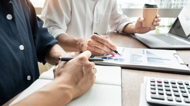 istock Midsection Of Businessman And Colleague Working On Table 1166180263