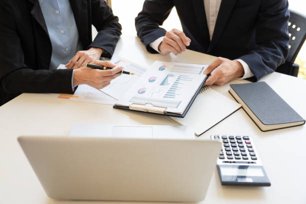 istock Midsection Of Business People Working On Table 1166180273