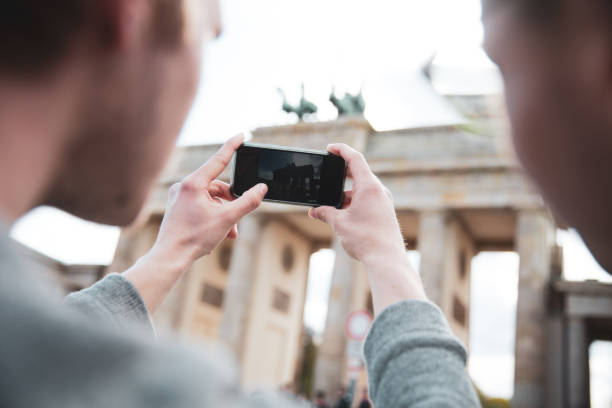 istock Two men visiting together Berlin - Brandenburg Gate 1166180493
