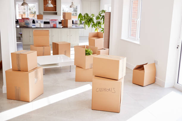 istock Stacked Removal Boxes In Empty Room On Moving Day 1166183928
