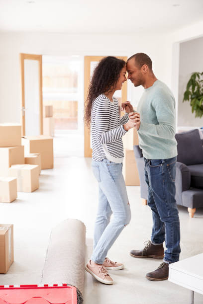 istock Loving Couple Surrounded By Boxes In New Home On Moving Day 1166184082