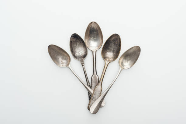 istock top view of shiny aged silver empty spoons on white background 1166184358