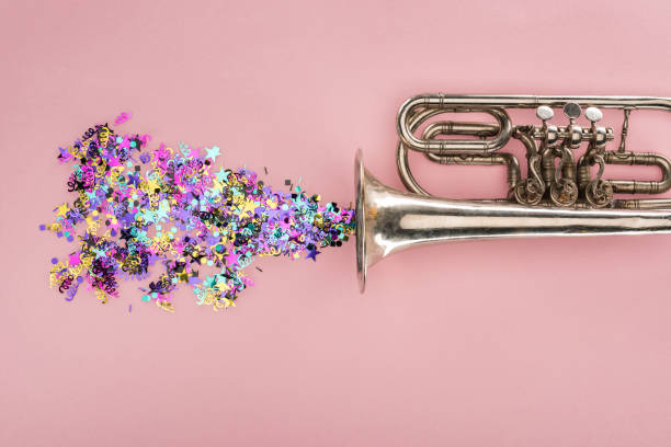 istock colorful confetti with trumpet on pink background 1166184411