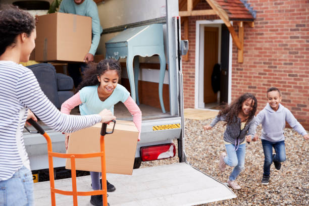 Family Unloading Furniture From Removal Truck Into New Home Family Unloading Furniture From Removal Truck Into New Home moving van stock pictures, royalty-free photos & images