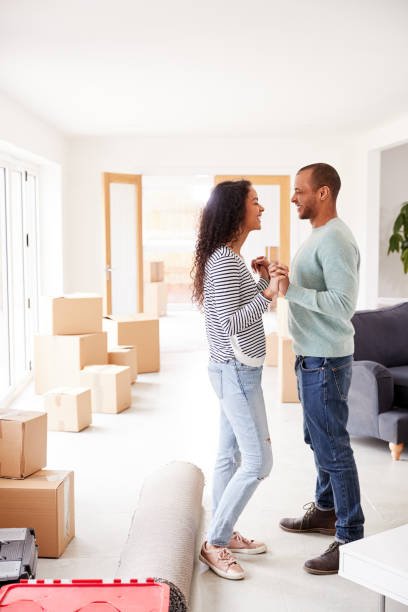 istock Loving Couple Surrounded By Boxes In New Home On Moving Day 1166185272
