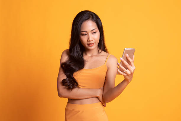 istock Young Asian woman with mobile phone. 1166185413
