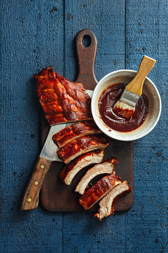 Grilled pork ribs with barbecue sauce on dark background