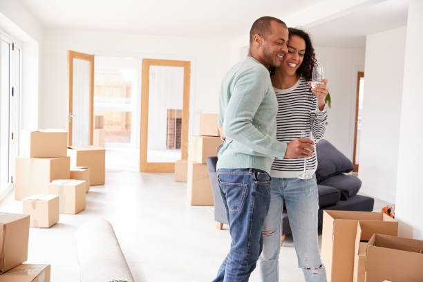 istock Couple Celebrating Moving Into New Home Drinking Champagne 1166187570