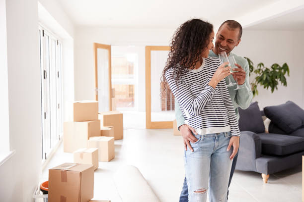 istock Couple Celebrating Moving Into New Home Drinking Champagne 1166187697