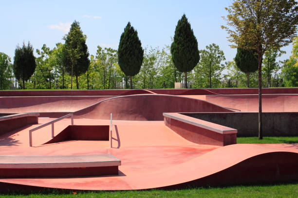 Empty public pink skate park waiting for skaters. Skateboard in Russia. Skate and Bike Park. A skate park at day light. Extreme sports ground stock photo