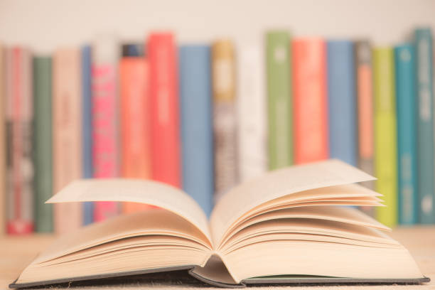istock Open books close-up in library, toned color background 1166193326